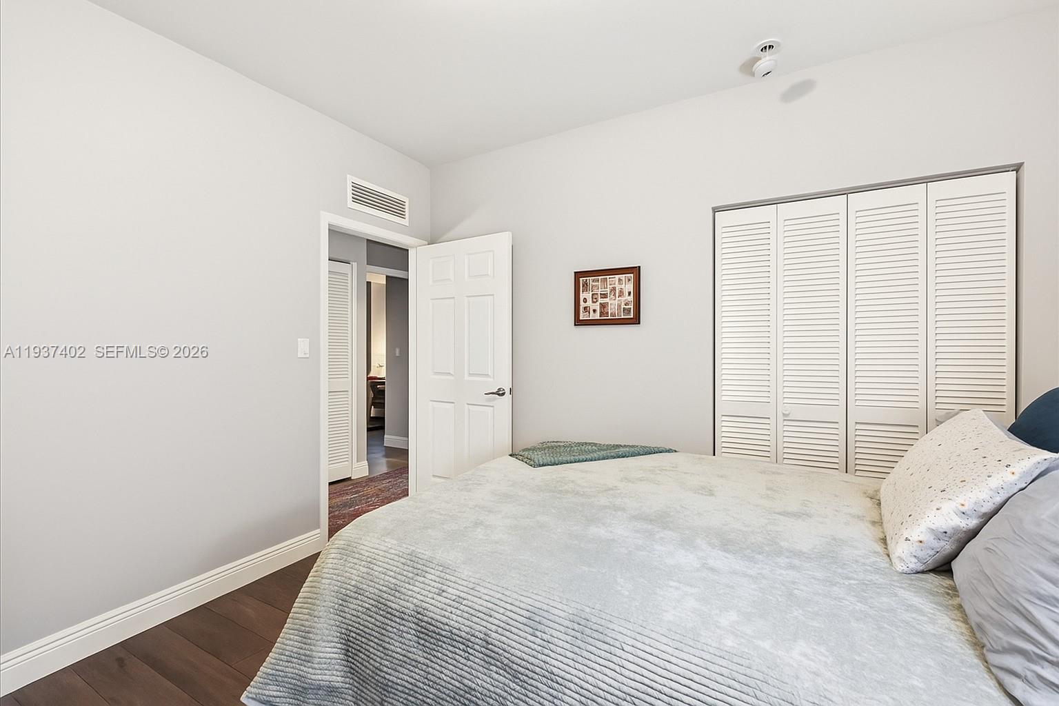 2730 Southwest 26th Street, Unit 2730 Miami, FL 33133 - Photo 13 of 21 a bedroom with a bed and a window
