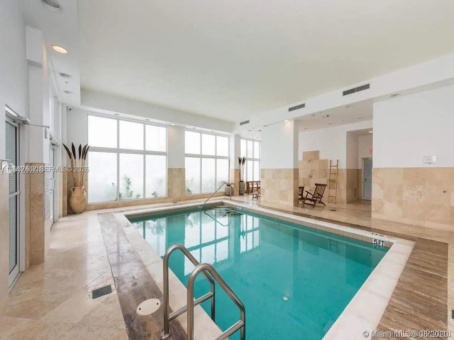 2730 Southwest 26th Street, Unit 2730 Miami, FL 33133 - Photo 22 of 24 a large white kitchen with swimming pool and a large window