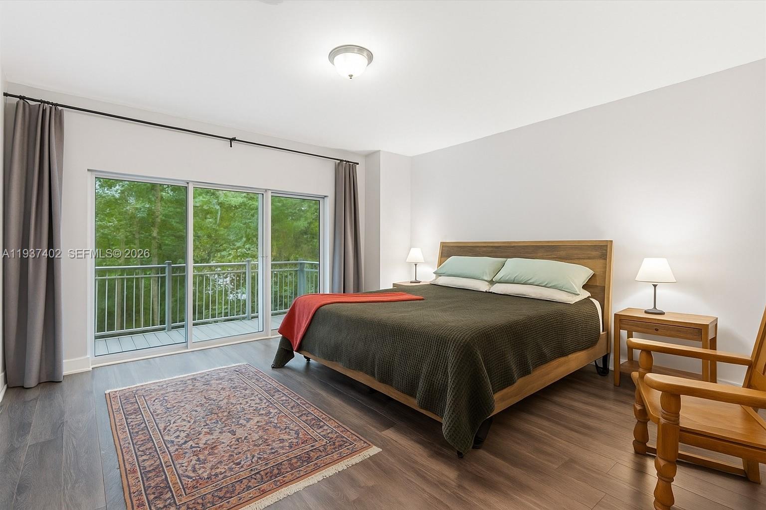 2730 Southwest 26th Street, Unit 2730 Miami, FL 33133 - Photo 10 of 21 a bedroom with a bed and wooden floor