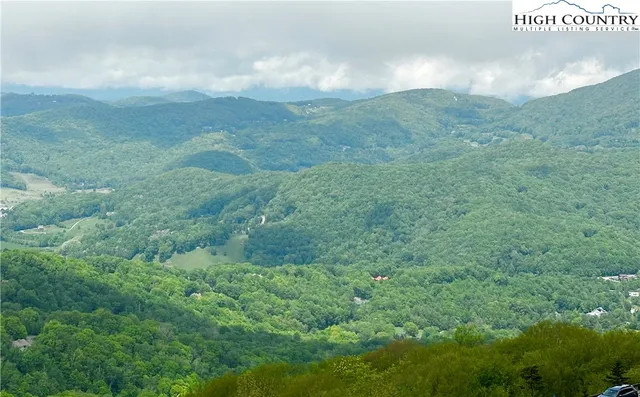 a kitchen with granite countertop a refrigerator stove top oven and sink