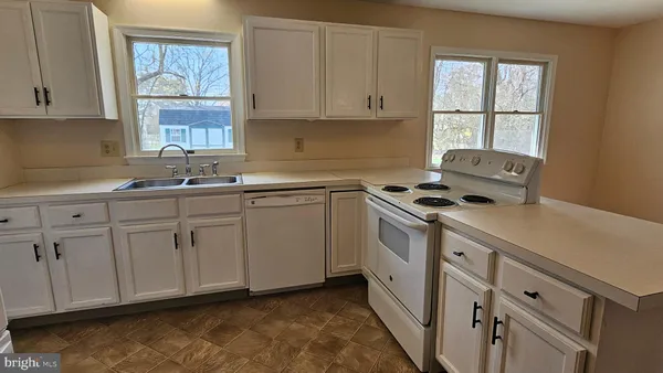 a kitchen with refrigerator a stove a sink and dishwasher