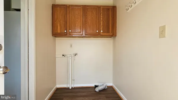 a kitchen with wooden floors and wide window