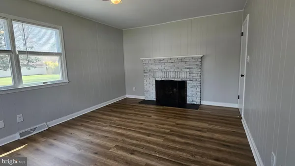 a room with a fireplace and window