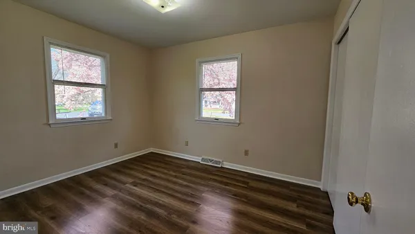 a view of a room with wooden floor and window