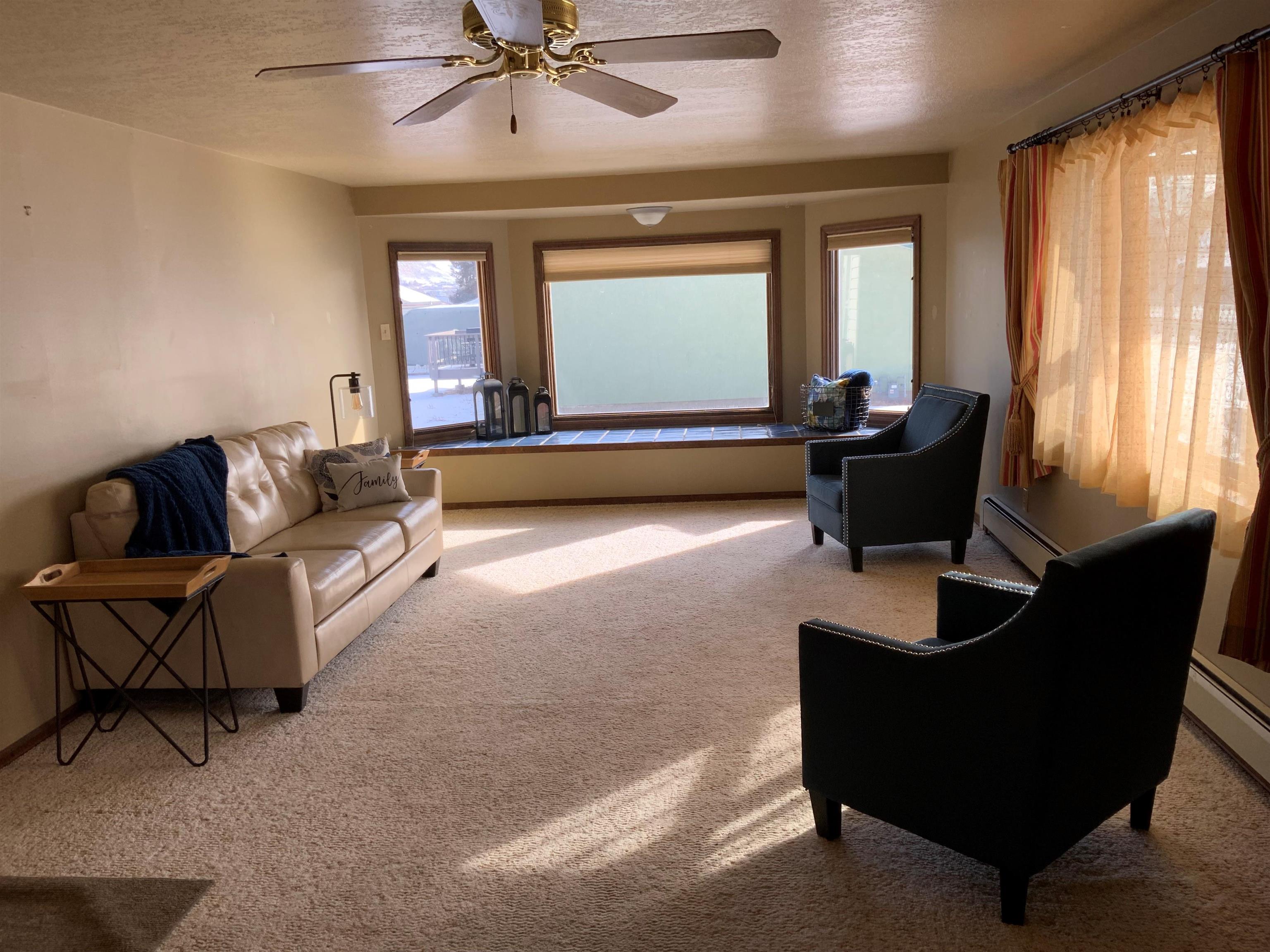 734-36 36 3/10 Road Palisade, CO 81526 - Photo 4 of 39 a living room with furniture and a large window