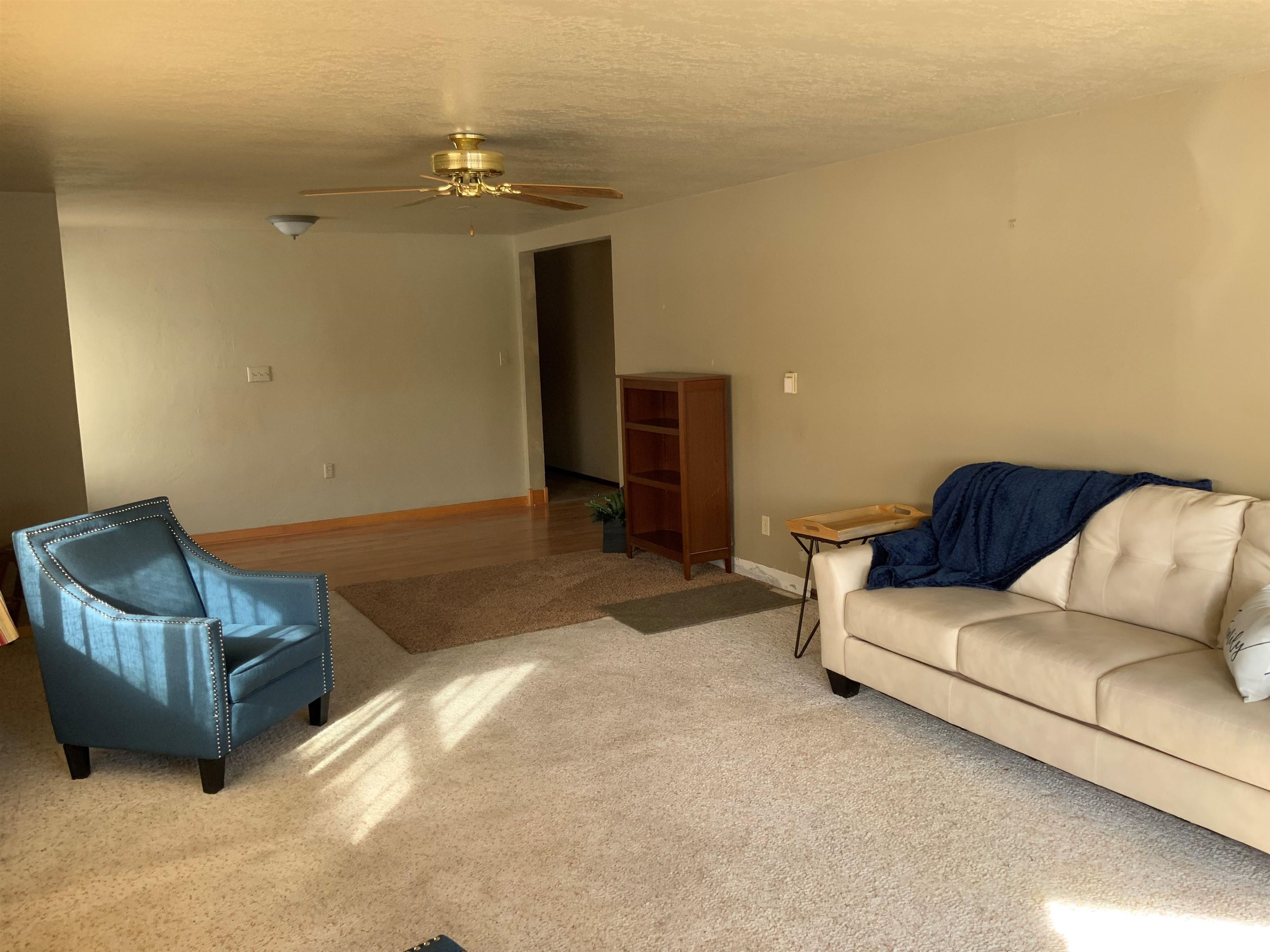 734-36 36 3/10 Road Palisade, CO 81526 - Photo 5 of 39 a living room with furniture and a chandelier