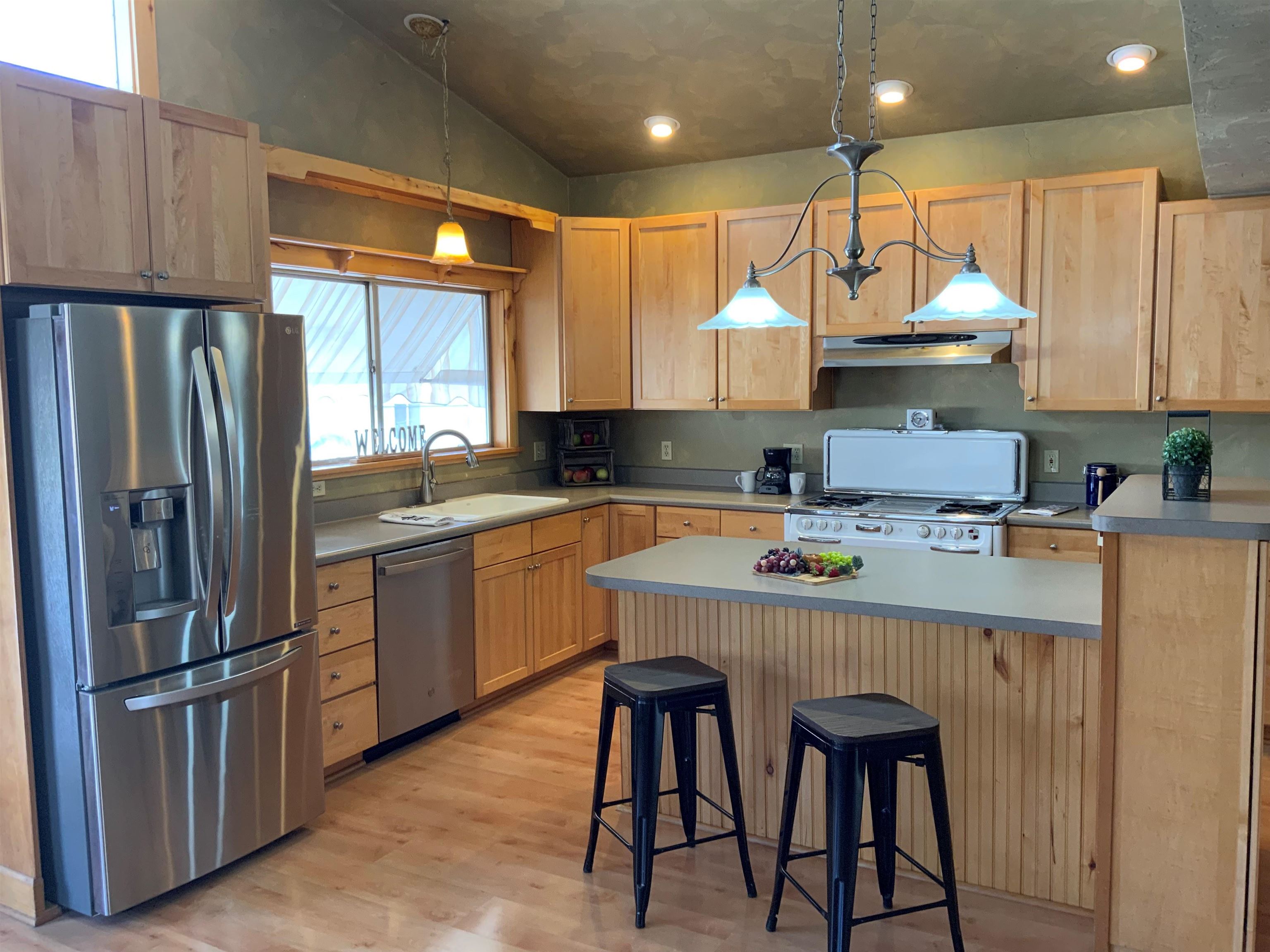 734-36 36 3/10 Road Palisade, CO 81526 - Photo 8 of 39 a kitchen with stainless steel appliances granite countertop a sink a stove a refrigerator and island