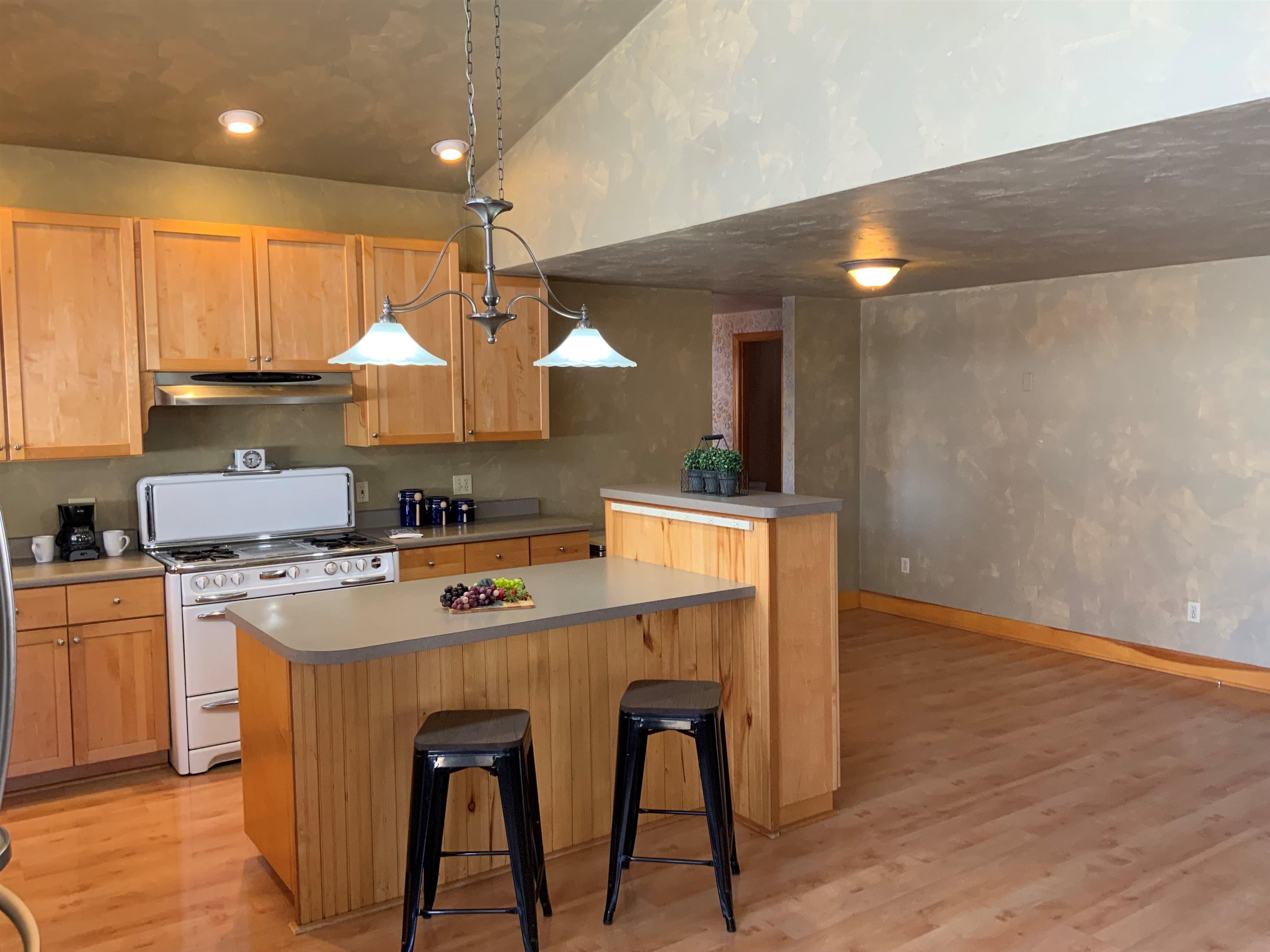734-36 36 3/10 Road Palisade, CO 81526 - Photo 9 of 39 a kitchen with stainless steel appliances a sink a stove a refrigerator cabinets and wooden floor