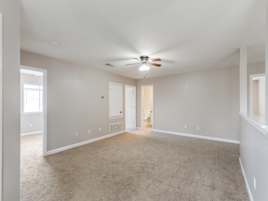 3005 Crownover Street Austin, TX 78725 - Photo 19 of 25 a view of an empty room with a ceiling fan