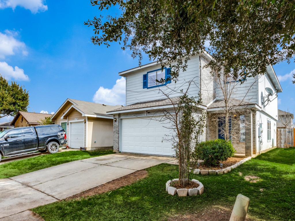 3005 Crownover Street Austin, TX 78725 - Photo 2 of 25 a front view of a house with a yard and garage
