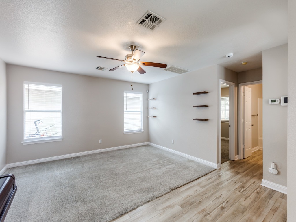 3005 Crownover Street Austin, TX 78725 - Photo 3 of 25 an empty room with windows and ceiling fan