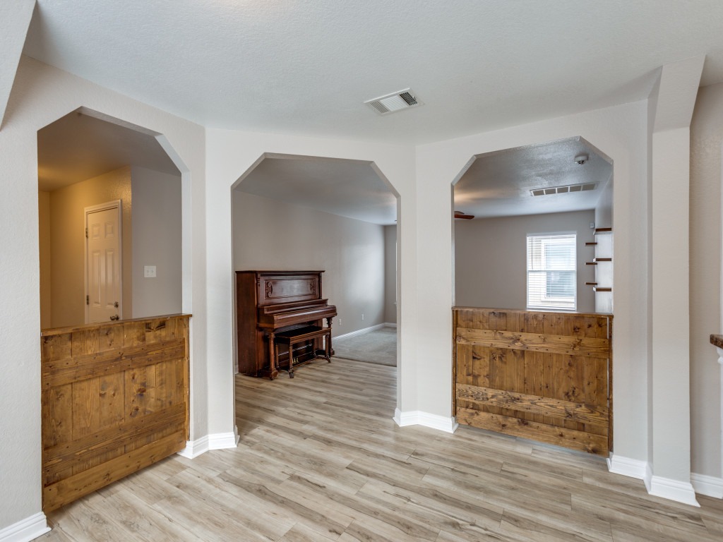 3005 Crownover Street Austin, TX 78725 - Photo 7 of 25 a view of a hallway view with wooden floor and furniture