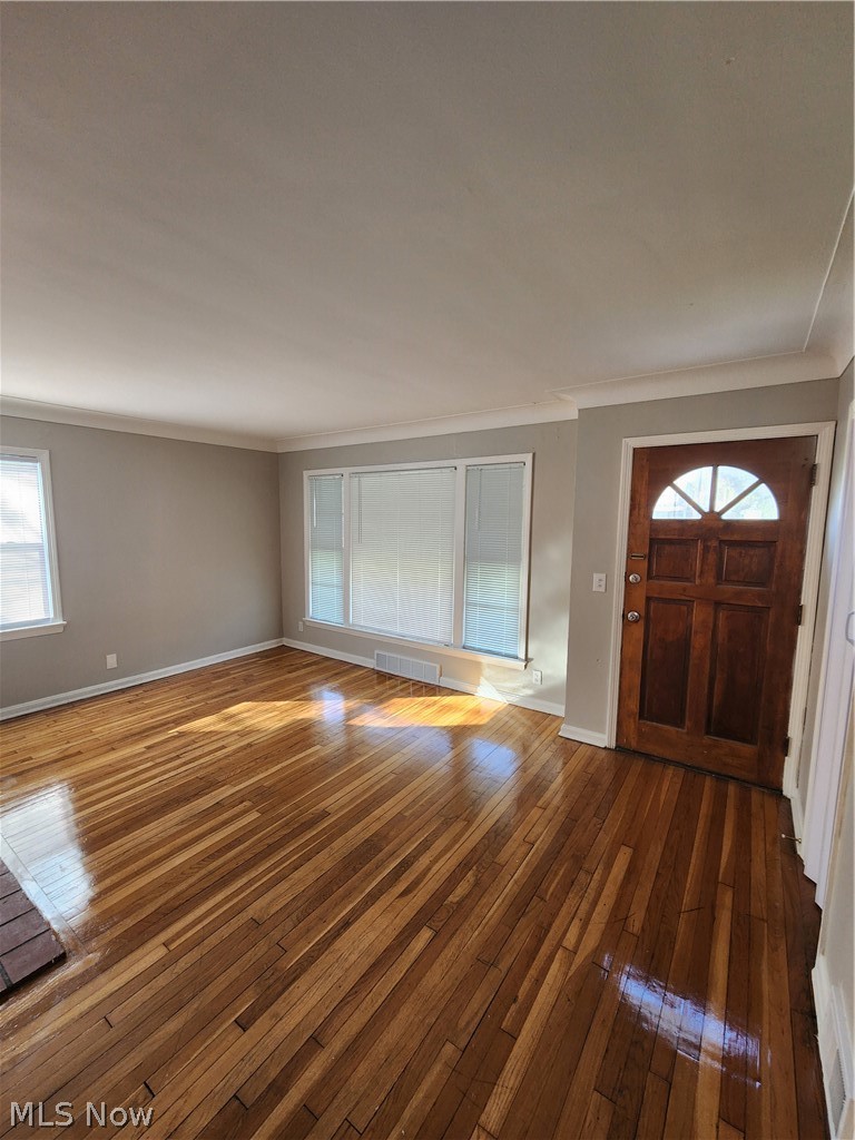 2199 North Taylor Road Cleveland Heights, OH 44112 - Photo 10 of 19 Unfurnished living room with dark hardwood / wood-style floors and ornamental molding