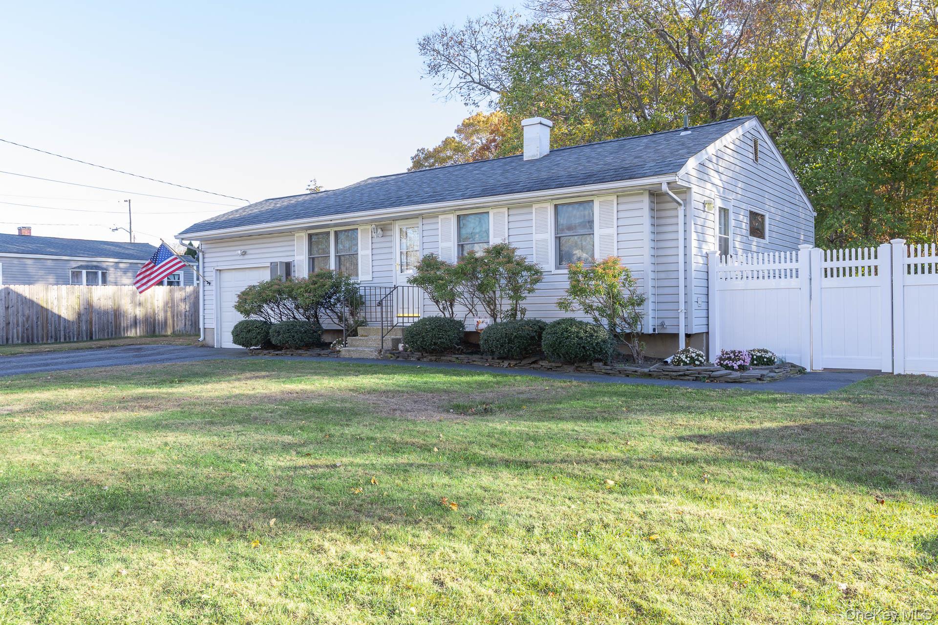 6 Talbot Lane Selden, NY 11784 - Photo 1 of 12 a front view of house with yard and green space