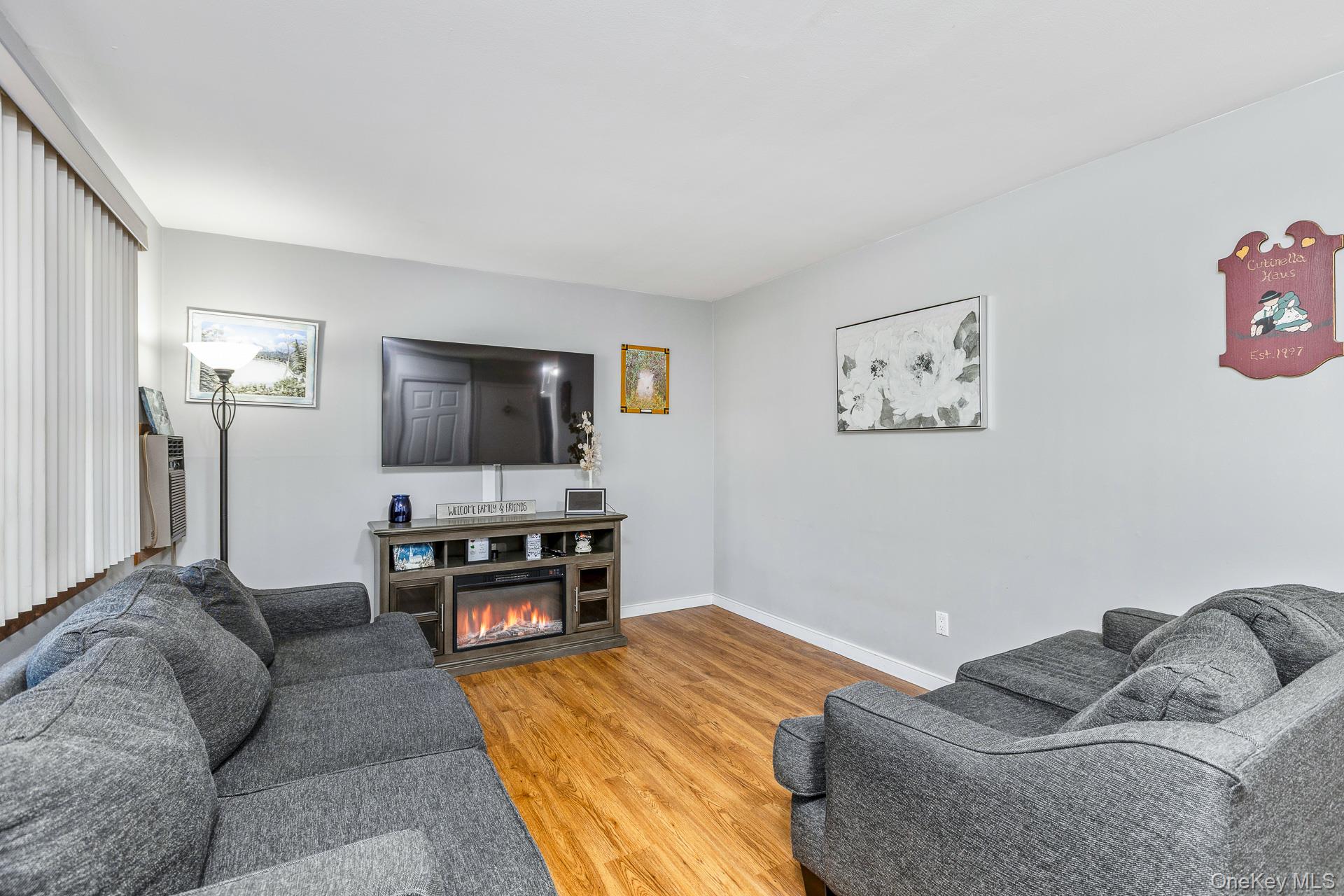 6 Talbot Lane Selden, NY 11784 - Photo 2 of 12 a living room with furniture and a flat screen tv