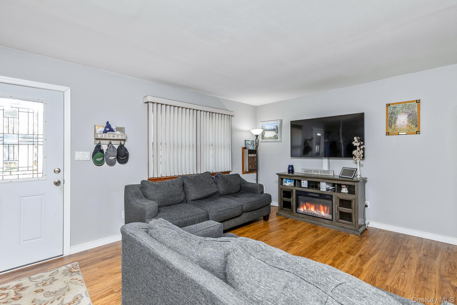 6 Talbot Lane Selden, NY 11784 - Photo 3 of 12 a living room with furniture and a flat screen tv
