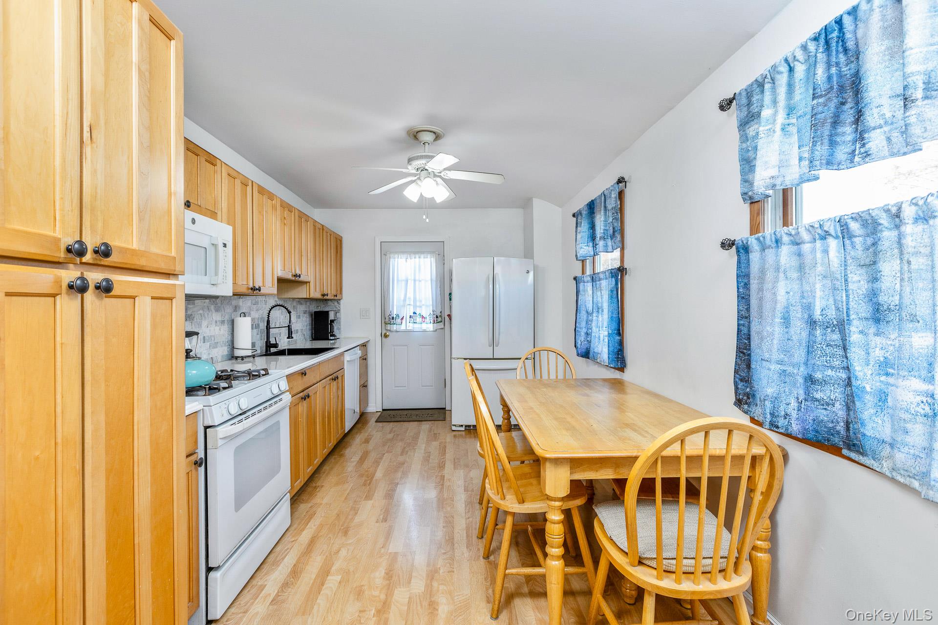 6 Talbot Lane Selden, NY 11784 - Photo 5 of 12 a kitchen with stainless steel appliances a stove a sink dishwasher and a refrigerator with wooden floor