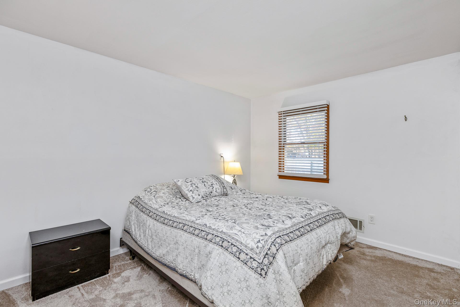 6 Talbot Lane Selden, NY 11784 - Photo 6 of 12 a bedroom with a bed and a window