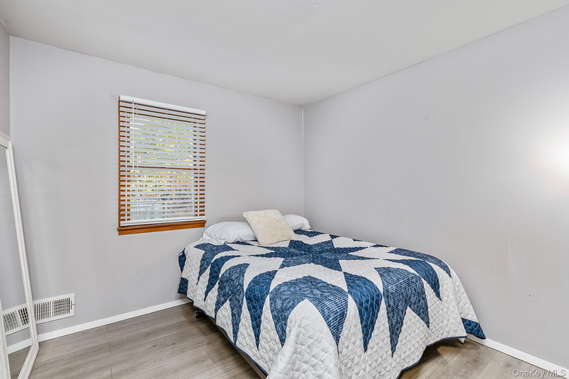 6 Talbot Lane Selden, NY 11784 - Photo 7 of 12 a bed sitting in a bedroom next to a window