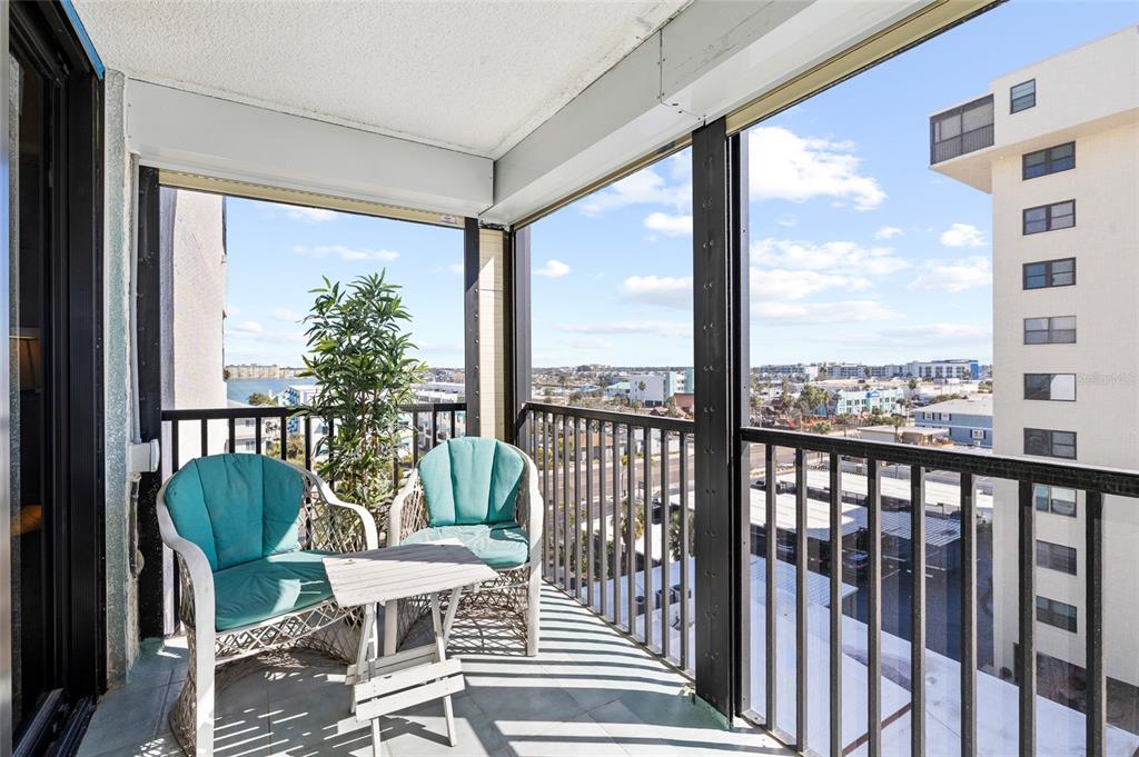 15462 Gulf Boulevard, Unit 601 Madeira Beach, FL 33708 - Photo 15 of 40 a view of a city from a balcony with furniture