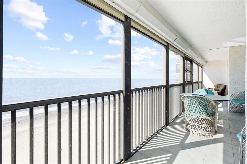 15462 Gulf Boulevard, Unit 601 Madeira Beach, FL 33708 - Photo 18 of 40 a view of a porch with furniture and wooden floor