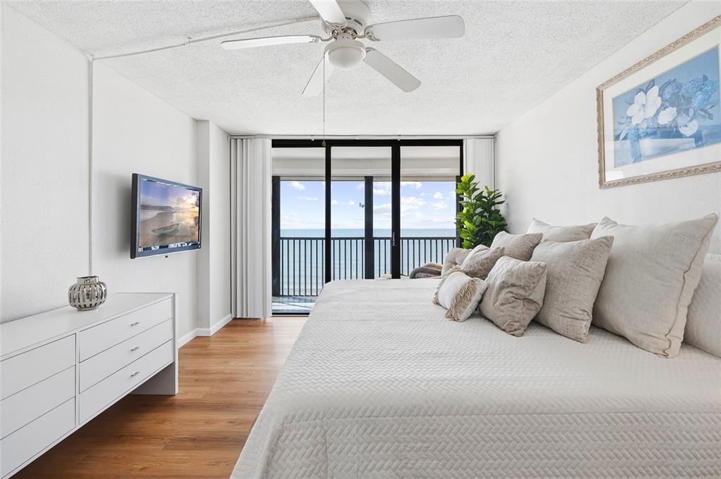 15462 Gulf Boulevard, Unit 601 Madeira Beach, FL 33708 - Photo 23 of 40 a bedroom with a large bed and a flat screen tv