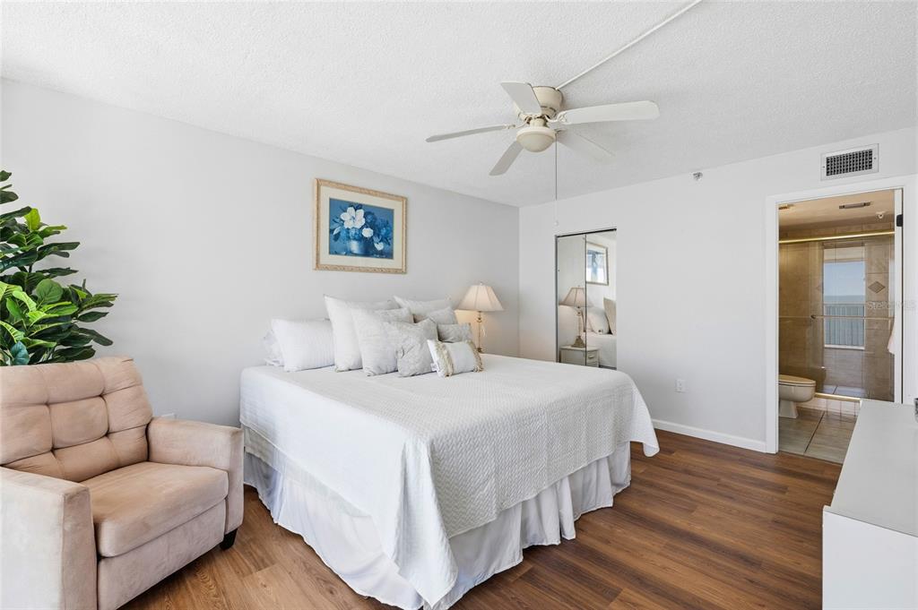 15462 Gulf Boulevard, Unit 601 Madeira Beach, FL 33708 - Photo 24 of 40 a bedroom with bed and wooden floor