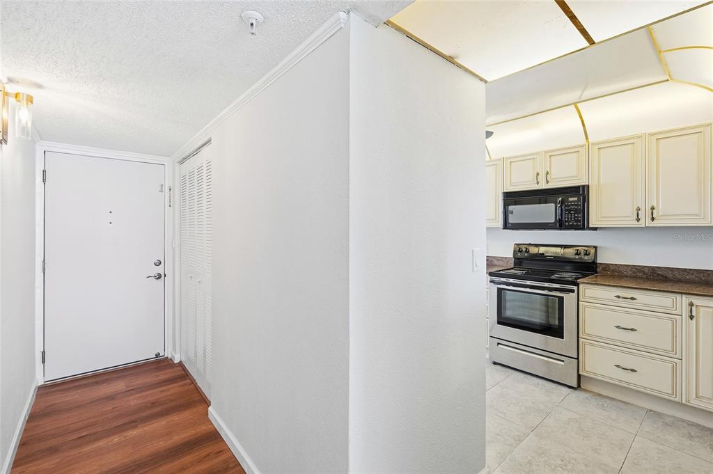 15462 Gulf Boulevard, Unit 601 Madeira Beach, FL 33708 - Photo 3 of 40 a kitchen with stainless steel appliances a stove and a microwave