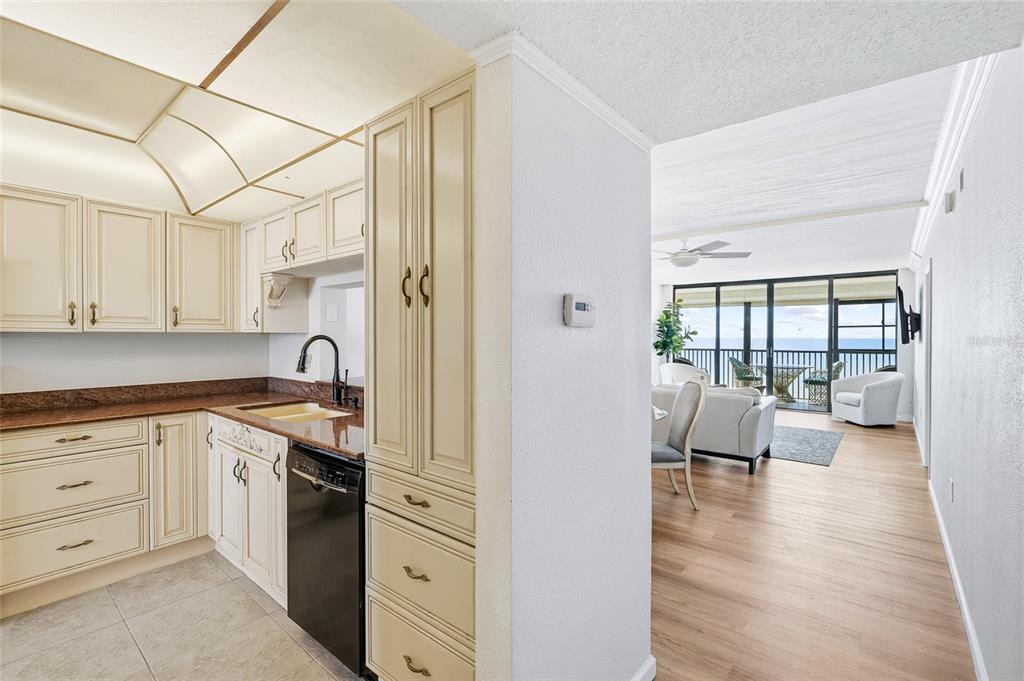 15462 Gulf Boulevard, Unit 601 Madeira Beach, FL 33708 - Photo 4 of 40 a kitchen with white cabinets and sink