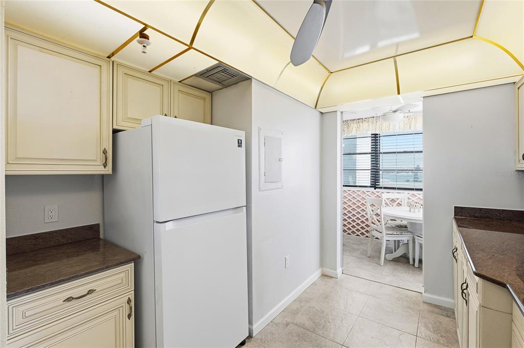 15462 Gulf Boulevard, Unit 601 Madeira Beach, FL 33708 - Photo 7 of 40 a white refrigerator freezer and a stove sitting inside of a kitchen