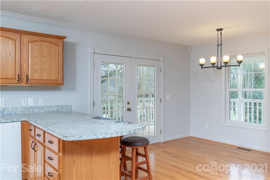 2381 Holbrook Road Fort Mill, SC 29715 - Photo 3 of 27 a kitchen with stainless steel appliances granite countertop a stove a sink dishwasher and cabinets with wooden floor