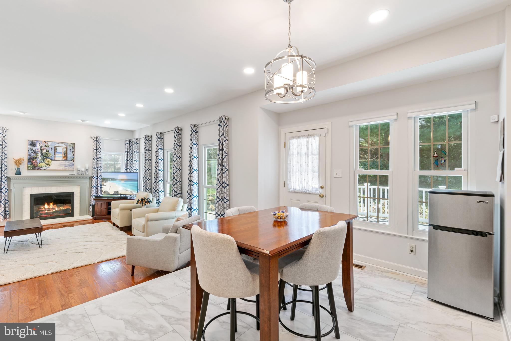 2803 Shadowridge Drive Olney, MD 20832 - Photo 11 of 55 a dining room with furniture a chandelier and wooden floor