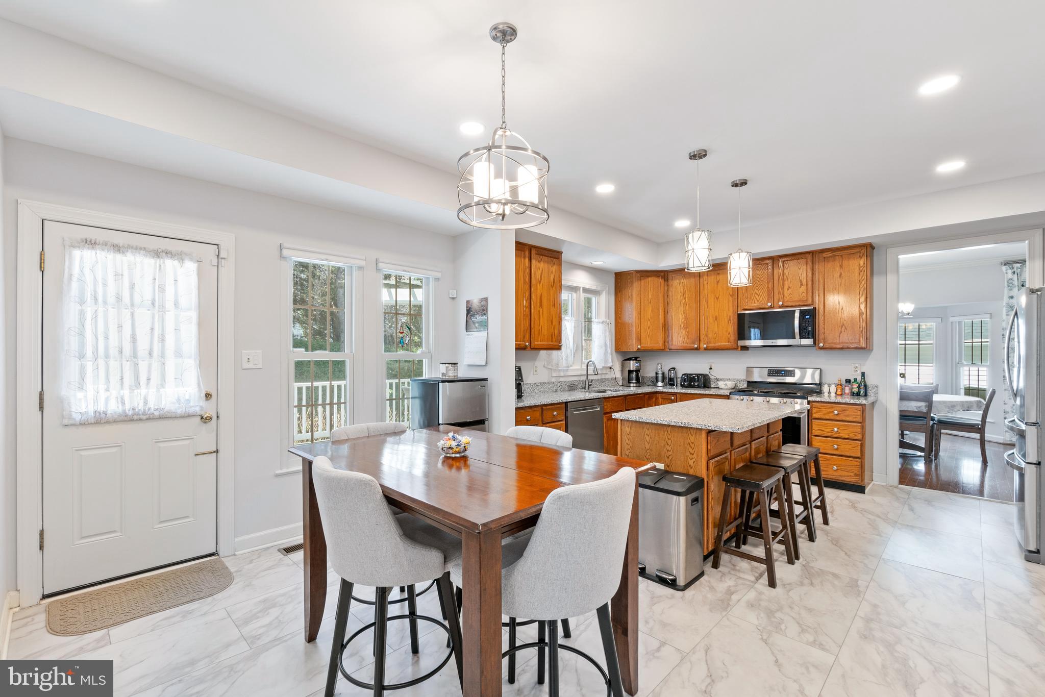 2803 Shadowridge Drive Olney, MD 20832 - Photo 12 of 55 a large kitchen with a table and chairs