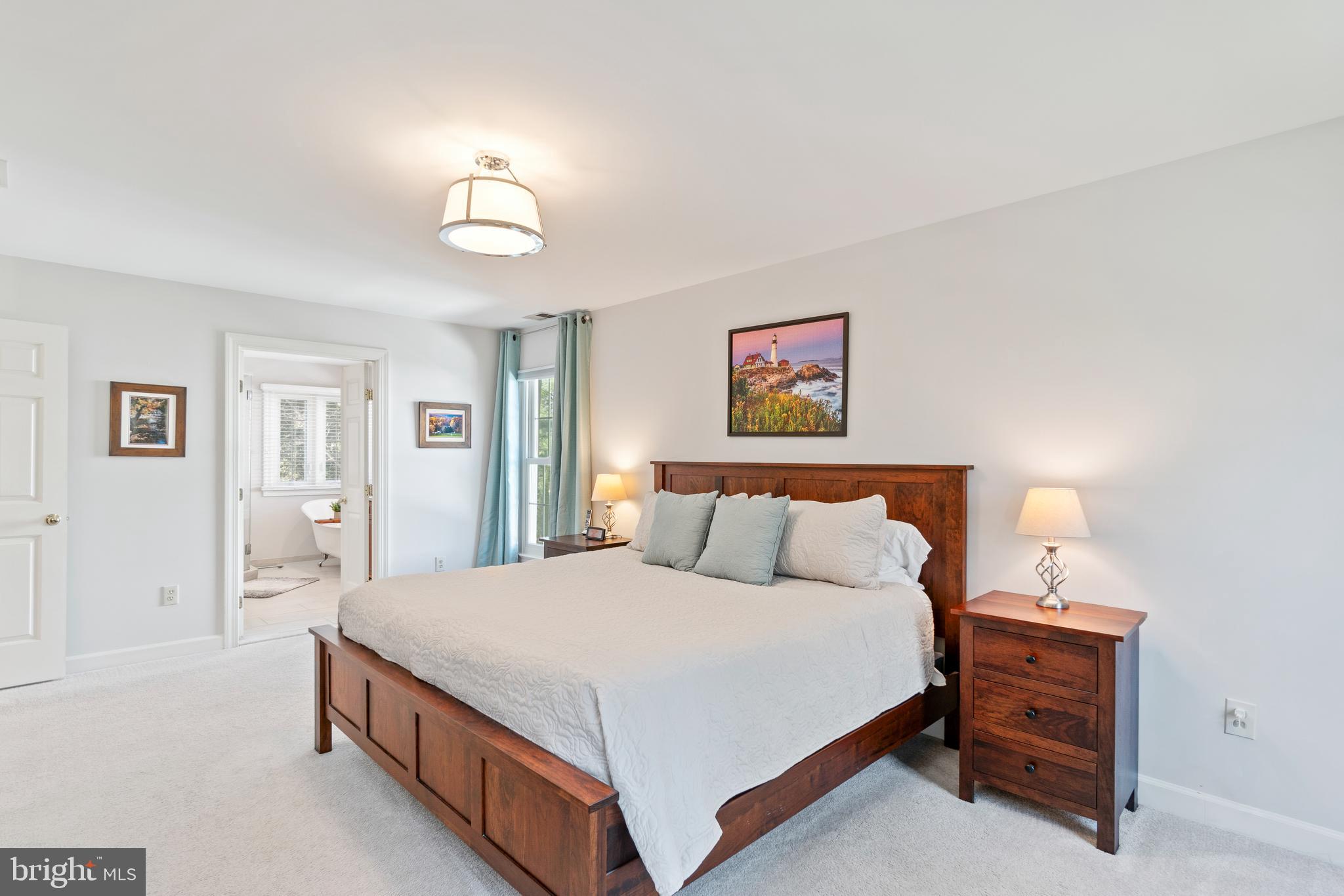 2803 Shadowridge Drive Olney, MD 20832 - Photo 33 of 55 a bedroom with a bed and a chandelier