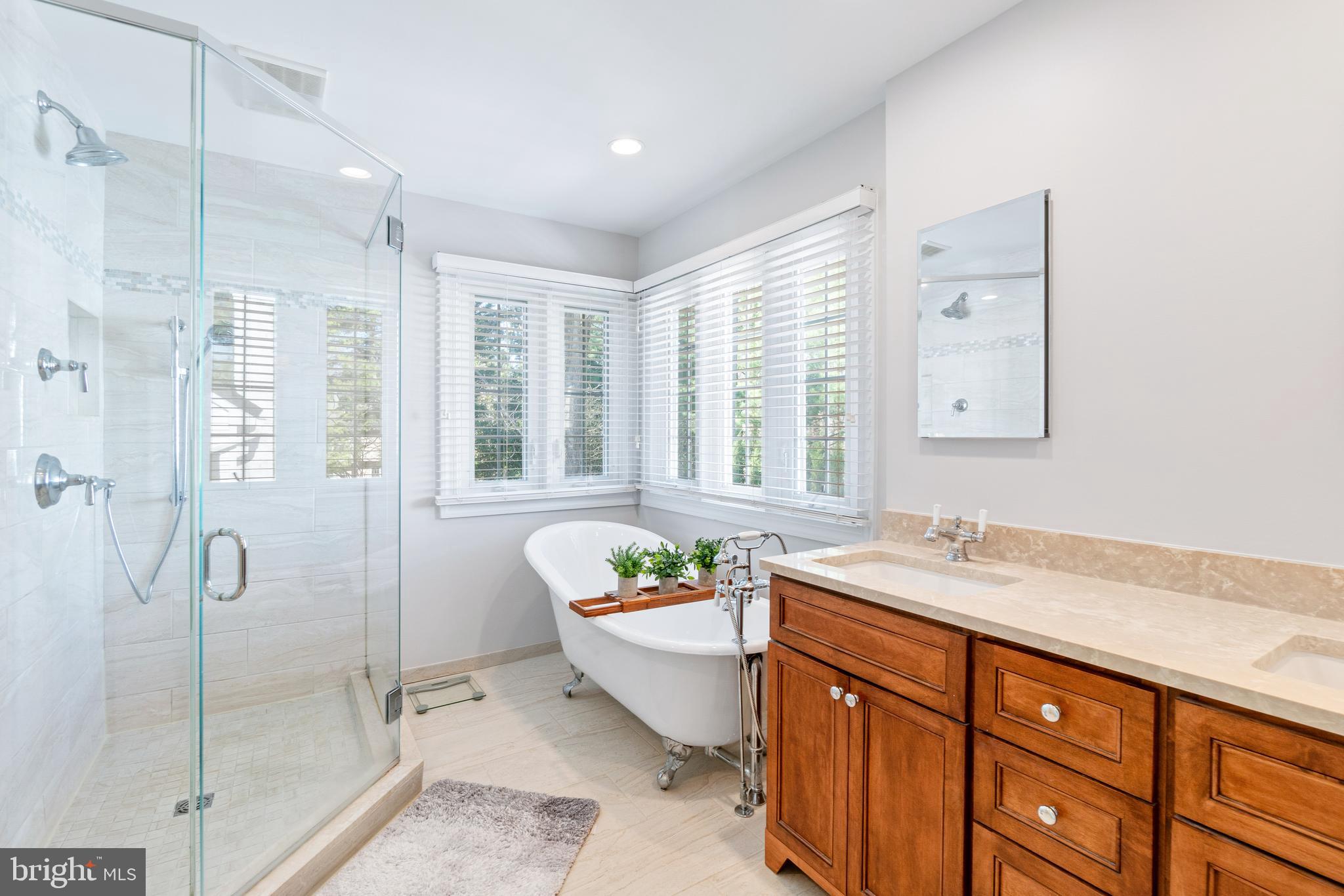 2803 Shadowridge Drive Olney, MD 20832 - Photo 35 of 55 a spacious bathroom with a granite countertop sink a toilet a mirror and shower