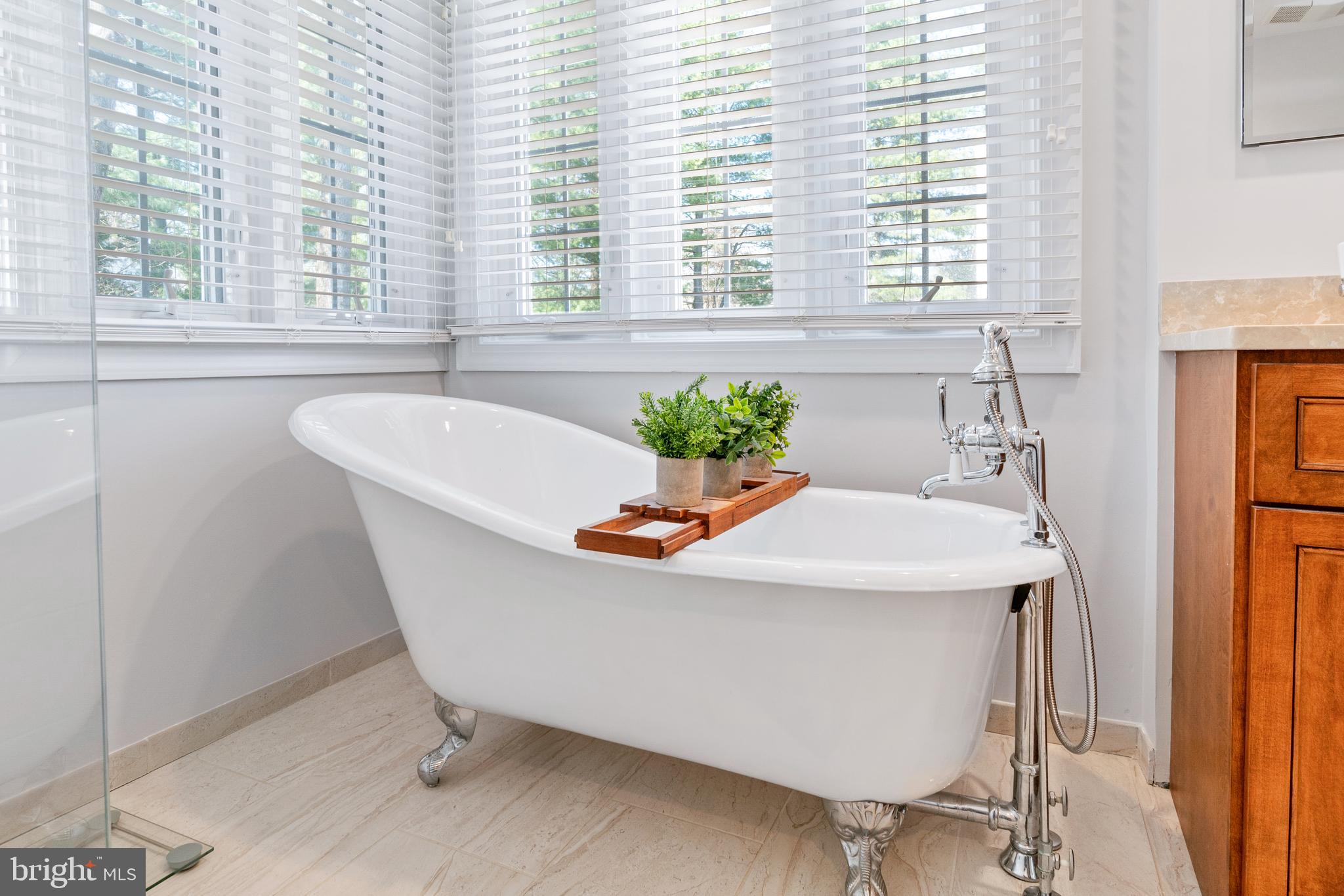 2803 Shadowridge Drive Olney, MD 20832 - Photo 36 of 55 a white bath tub sitting in a bathroom next to a window