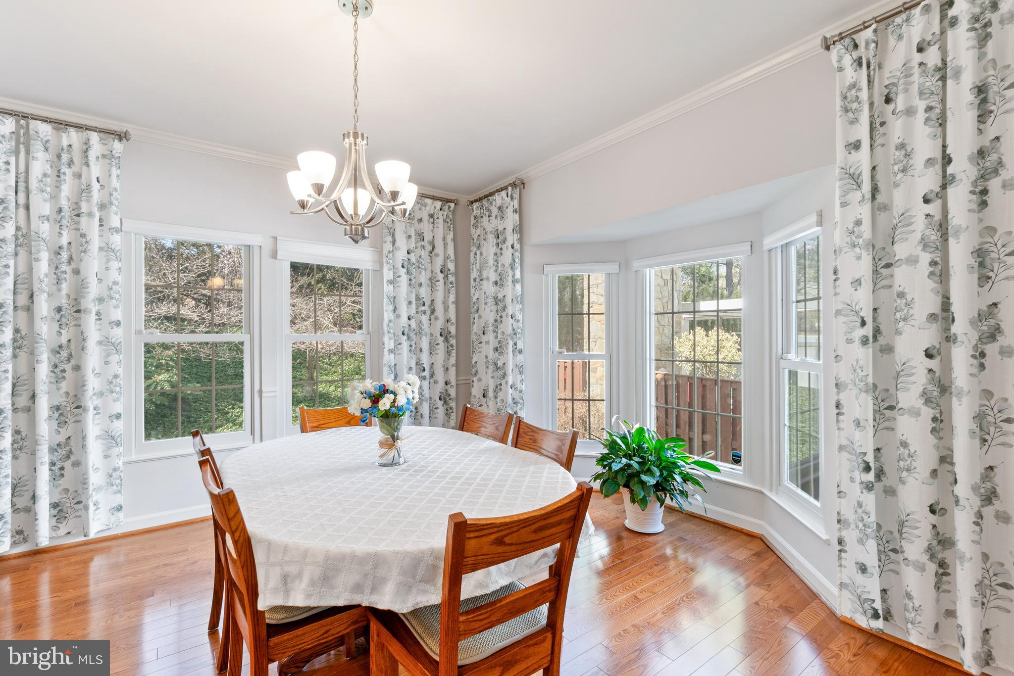 2803 Shadowridge Drive Olney, MD 20832 - Photo 4 of 55 a dining room with furniture a chandelier and a rug