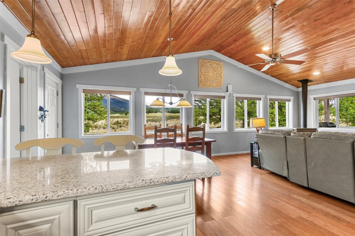 485 High Creek Road Fairplay, CO 80440 - Photo 11 of 32 a kitchen with granite countertop a stove a sink and dishwasher wooden cabinets with granite countertops