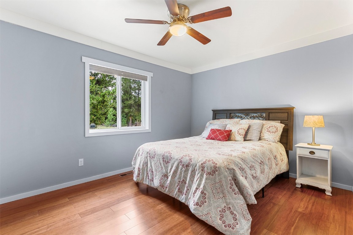 485 High Creek Road Fairplay, CO 80440 - Photo 22 of 32 a bedroom with a bed and a chandelier