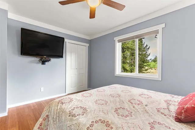 a bedroom with a large bed and a flat screen tv