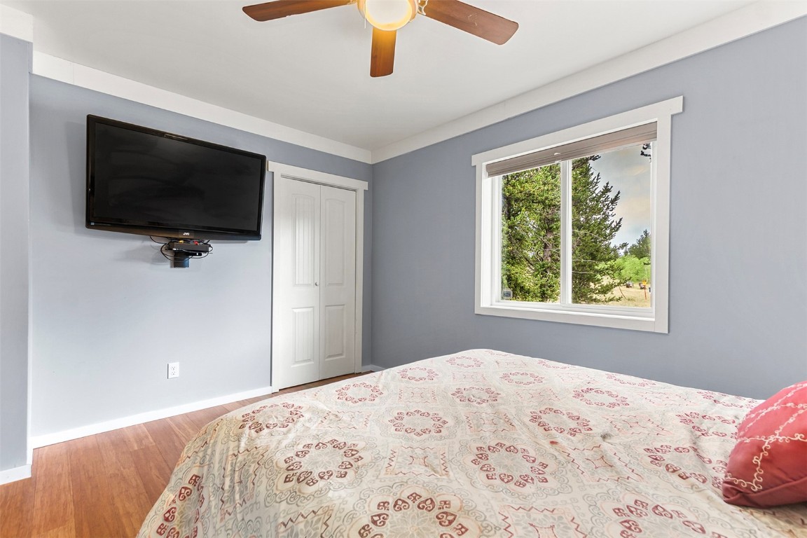485 High Creek Road Fairplay, CO 80440 - Photo 23 of 32 a bedroom with a large bed and a flat screen tv