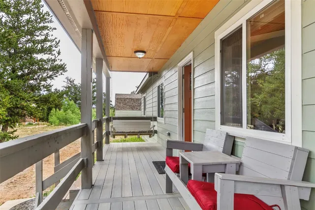 a balcony with furniture and a potted plant