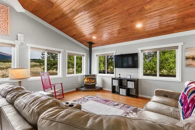 a bedroom with furniture and large windows