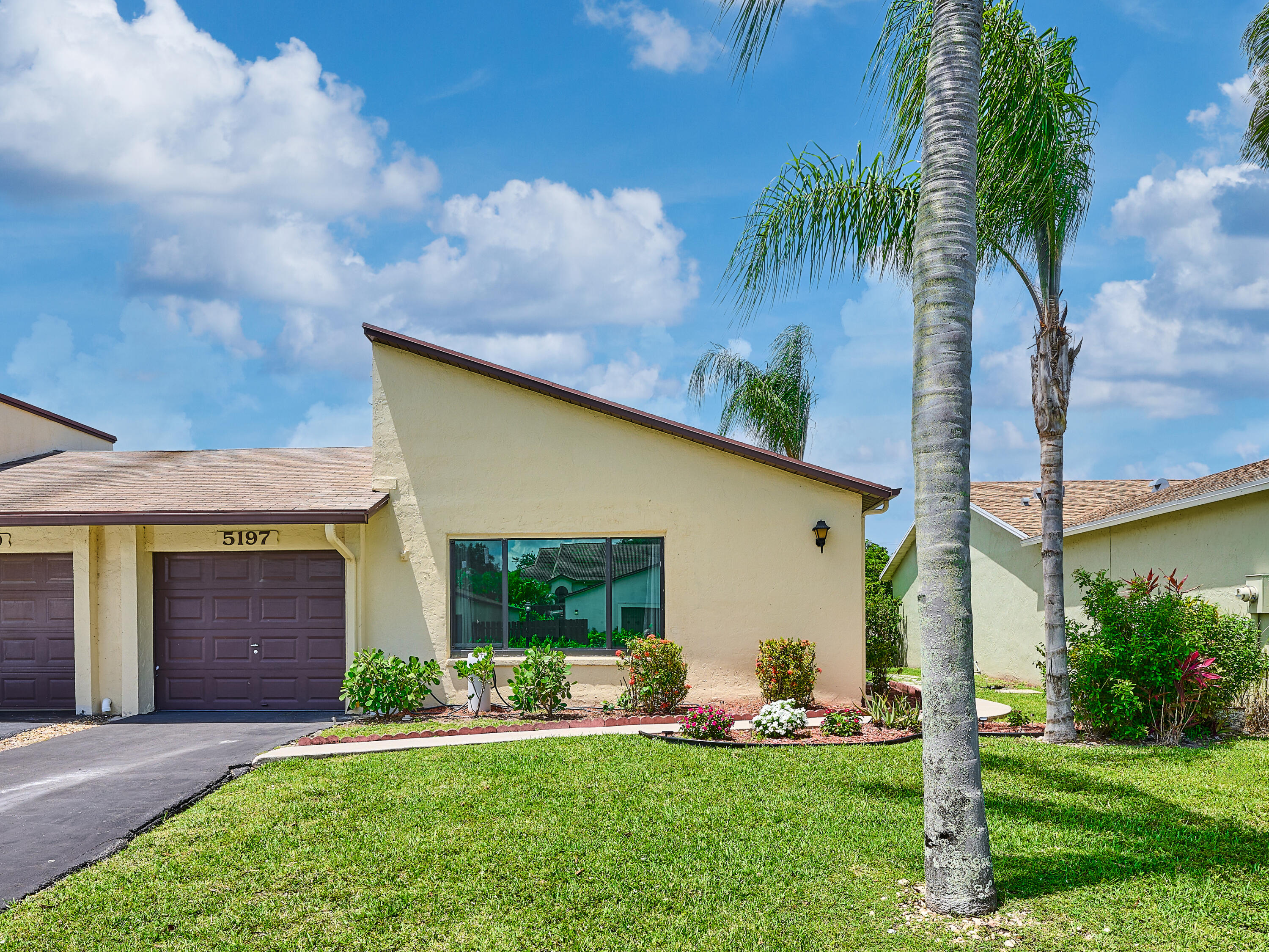 5197 Minto Road Boynton Beach, FL 33472 - Photo 1 of 32 a front view of a house with a yard and garage