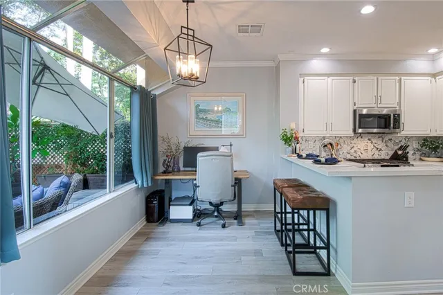 a view of workspace with wooden floor and breakfast area