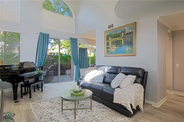 a backyard of a house with table and chairs under an umbrella