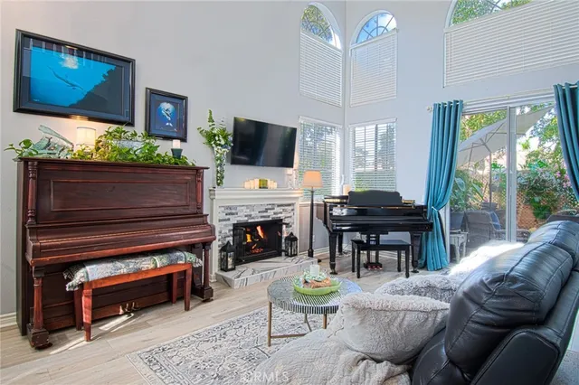 a living room with furniture and a floor to ceiling window