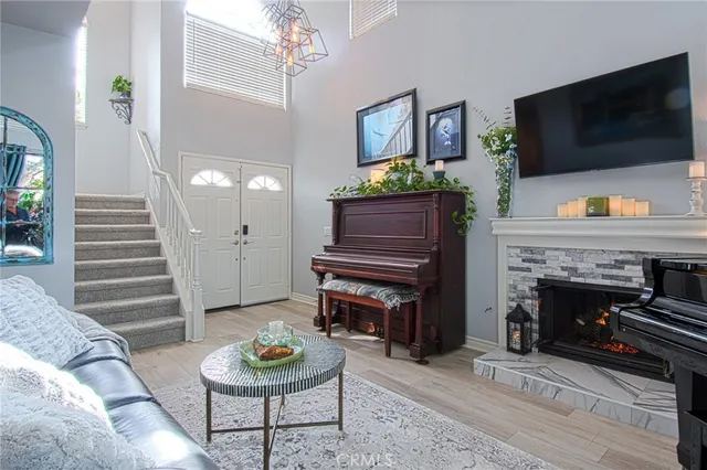 a living room with furniture a flat screen tv and a fireplace