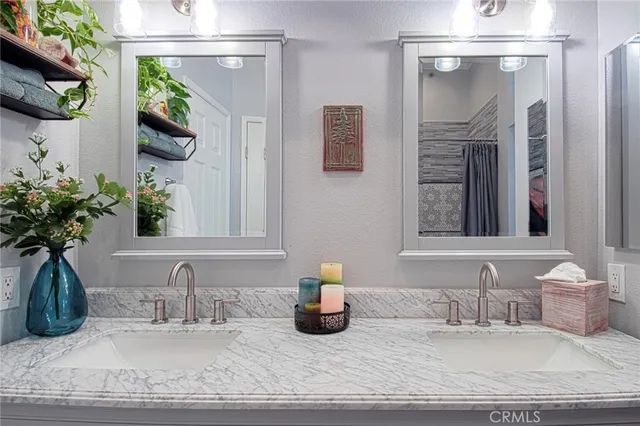 a en suite bathroom with a granite countertop tub and a large window