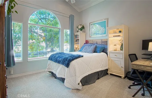 a spacious bedroom with a bed and a window
